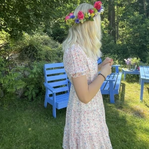 Klänning  - Supersöt blommig klänning i väldigt härligt material. Den är både luftig och har ett mjukt material mot huden. V-ringad med knappar högst upp. Går ner till strax över knäna. 