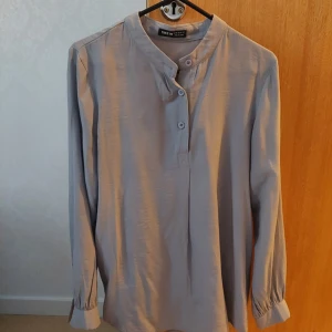 Grey blouse  - Soft and comfy material.  Used but no damages.  Do contact me for more photos or if you have any questions. [Product Measurement - Shoulder: 37 cm, Length: 71 cm, Sleeve Length: 60 cm, Bust: 93 cm, Cuff: 20 cm, Bicep Length: 33.5 cm]