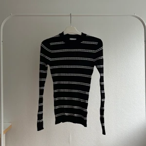 Svart ribbad tröja - Ribbad tröja från H&M med vita ränder. I bra skick