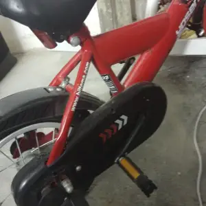 Röd fin cykel med hjälp hjul 