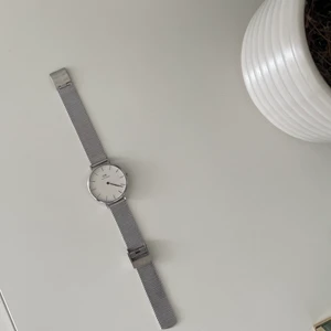 Daniel Wellington klocka i silver - Knappt använd Daniel Wellington klocka i silver och så får man med ett vitt armband i köpet. Fungerar exakt som den ska.