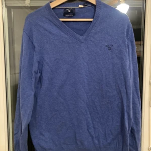 GANT Tröja M - Blå tröja från GANT. I bra skick förutom en liten tråkig fläck på ena armen. 