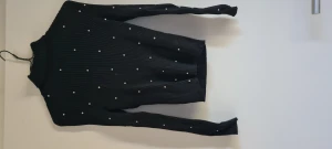Stickad tröja  - Svart stickad tröja med stenar på. Använd få gånger. Storlek M enligt lappen men skulle säga att tröjan mer är som en xs.