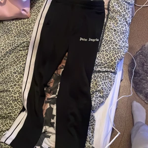 Palm Angels - Palm angels byxor, köpta på farfetch. Storlek Mediun, lapp sönder men är enkelt att fixa så skulle säga att skicket är 8/10.