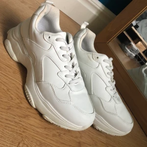 Vita sneakers - Vita sneakers från dinsko med resårband istället för knytning! Endast använda en gång och har endast några få pyttesmå fläckar som säkert går att torka bort. Ganska hög sula och säljer eftersom de inte kommit till användning! Kontakta mig vid intresse 💞