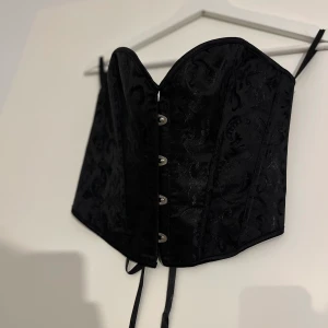 Korsett - Svart kort korsett i bra kvalité i storlek S, men justerbar i ryggen. Aldrig använd, endast testad.