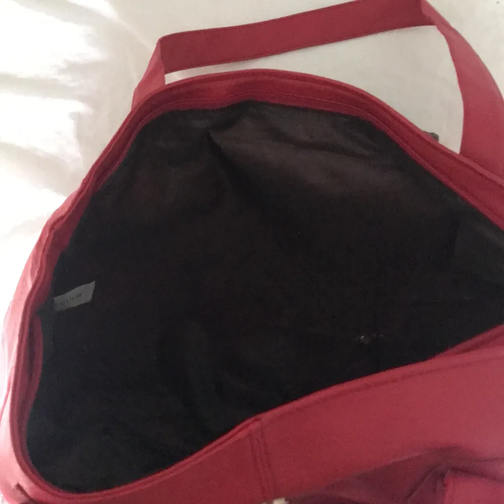 En röd aldrig använd Daniel hechter väska! Fick av farmor eftersom hon aldrig använt men kommer inte häller använda!. Väskor.
