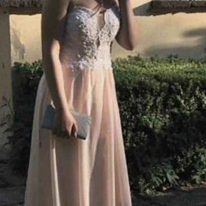  - Heejjj!  Klänningen är aprikos färgad med pärlor vid bysten.  Klänningen är med snörning bak. Klänningen är 1,29 meter lång. Klänningen har använts 1 gång   Köpte den för 1000 kronor säljer de nu för 700 kronor😋