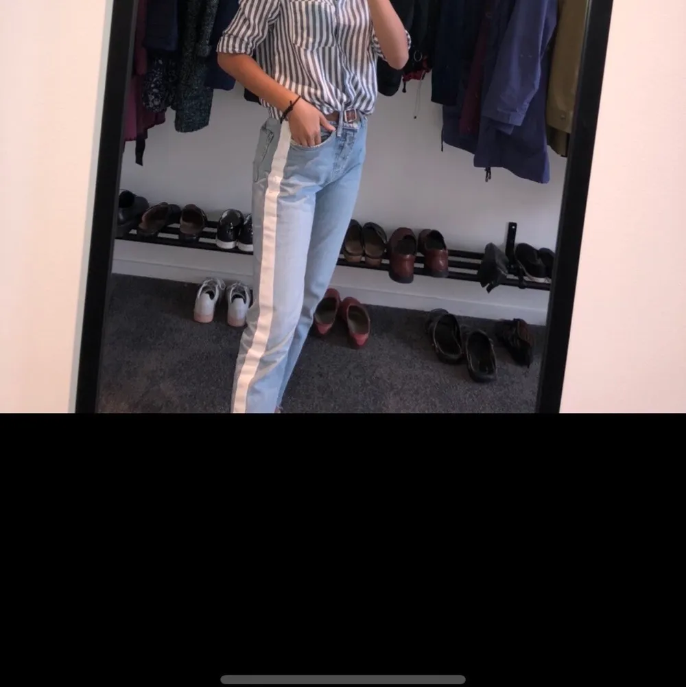 Säljer dessa otroligt snygga mom jeans med en vit stripe på varsinn sidan i mycket bra skick🤩 Stl 34. Pris 300kr:). Jeans & Byxor.