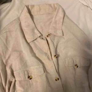  - Ljus beige linnéskjorta. Aldrig använd. Vid frakt står köparen för fraktkostnaden 