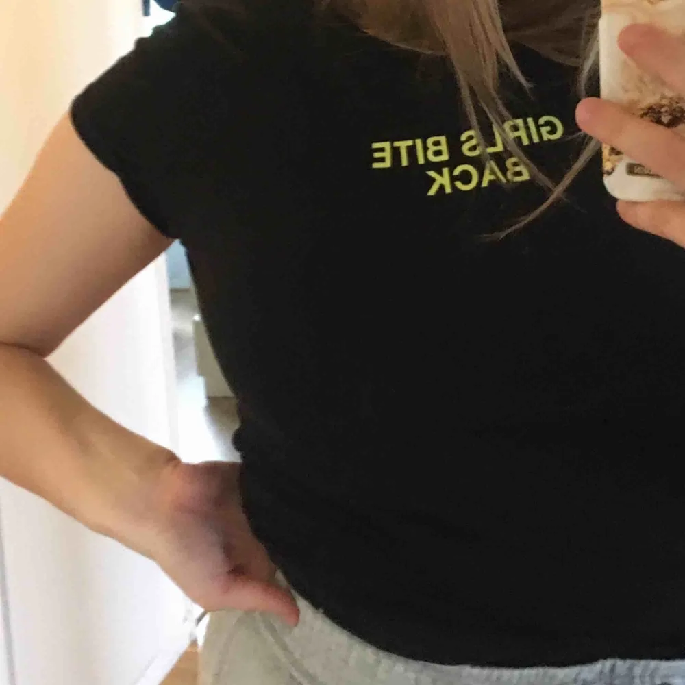 Svart snygg t-shirt från New Yoker. Väldigt bra skick. Texten är e neongrön och det står ”girls bite back”. T-shirts.