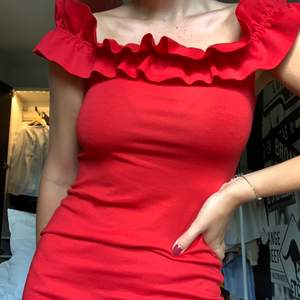 Röd klänning som antingen kan bäras som off-shoulder eller ”vanligt”. Tight i modellen, går till knäna och är relativt stretchig men rejäl i materialet. Ganska välanvänd men fortfarande i fint skick. Frakt ingår ej. 