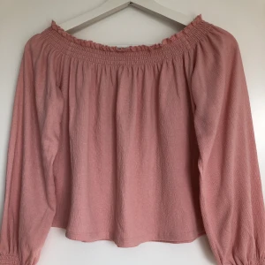 Ljusrosa offshoulder topp - Toppen är sparsamt använd och är en modell mittemellan croppad och ”vanlig” den går alltså ner till naveln ungefär på mig. Jag är 1,60 cm.  