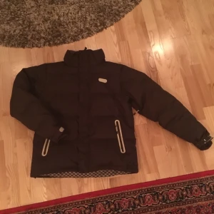  - Puffig brun vinteejacka i fint skick, med avtagbar luva. Märke: DC