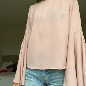 Rosa blus från NAKD - Supersöt rosa blus med utsvängda armar. Blusen är i storleken 34 men skulle mer säga att den är som en 36.