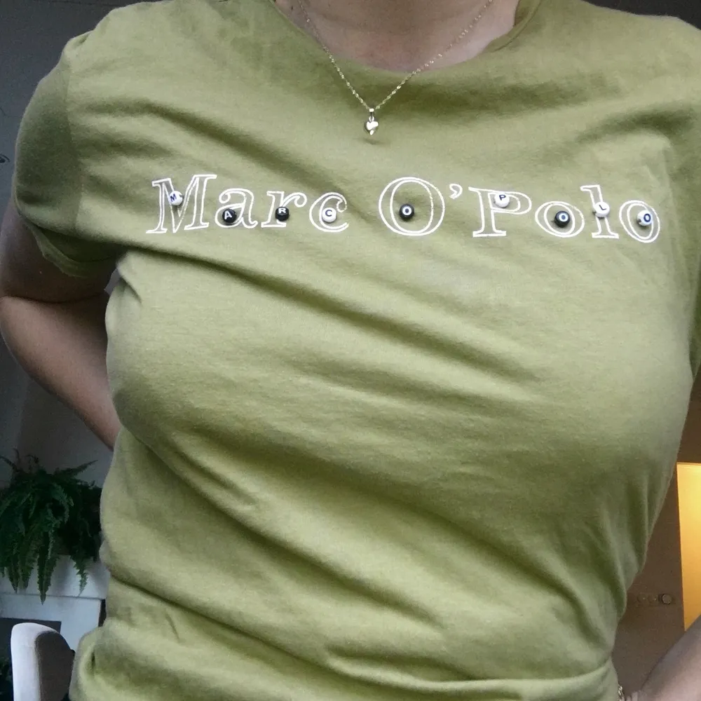 Grön T-shirt från märket Marco Polo med ”bokstavspärlor” som jag sytt på själv. !Frakt ingår!. T-shirts.
