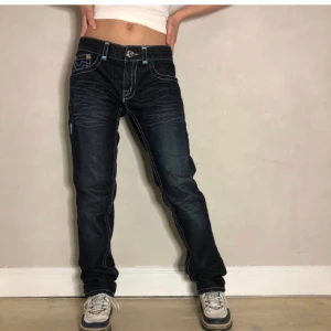 True religion jeans  - Ett par JÄTTE snygga true religion jeans som jag köpt på plick men tyvärr var förstora. De har en blå kontrastsöm som är sjukt snyggt! Personen är 170 och bär 34/32 midjemått 82cm och innebenslängden är 88cm, BUDA!💕💕💕