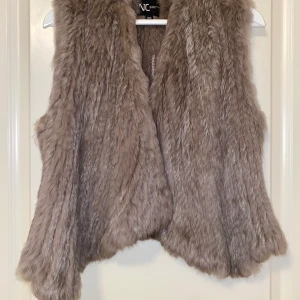 Brun Pälsväst, äkta päls. - En snygg och enkel väst i äktapäls storlek xs/s använd ett fåtal gånger. 