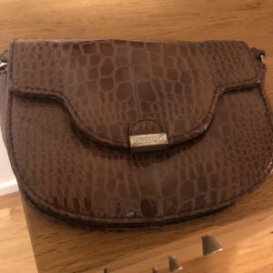  - a small leather imitation crossbody bag, suits all outfits, adds on as a nice accessory 