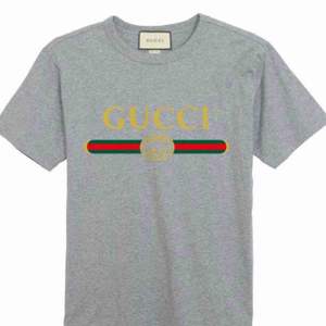 Gucci  Fabric:100 Percent Cotton   Color:Grey    Sleeve:Half Sleeve   Pattern:Printed   Neck Shape:Round   Fit:Regular Fit
