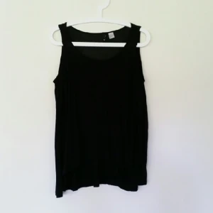  - Långärmad tröja med cutouts på axlarna.