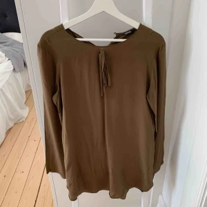  - Blus i olivfärg, strl 38 från märket turnover 