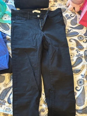 Svarta jeans från Gina tricot Molly  - Snygga svarta jeans från Dr. Denim med klassisk femficksdesign och raka ben. Jeansen har normal midja och stängs med dragkedja och knapp. Perfekta för en clean och stilren look. Materialet är stretchigt för extra komfort.