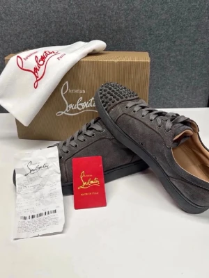 Christian Louboutin svarta sneakers - Snygga svarta sneakers från Christian Louboutin i mocka med svarta nitar på tån. Klassisk låg modell med svarta skosnören och diskret logga på sidan. Skorna har en stilren design och är tillverkade i högkvalitativt material. Dem är lite svarta på den röda sulan så ni vet okej skick 