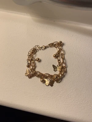 fjäril-armband - guldigt armabdn