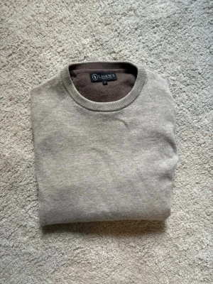 Stickad ljusbeige tröja - Säljer denna snygga ljusbruna/beigea stickade ulltröjan i 100% ull från det italienska lyxmärket Lagency. Köptes ny i Italien för 2700kr. Aldrig använd och helt sprillans ny. 