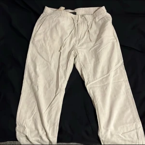 Beiga linnebyxor med snörning från H&M  - Luftiga beiga linnebyxor från H&M i regular fit. Byxorna har elastisk midja med snörning och raka ben. Perfekta för varmare dagar och chill vibes. Snygg minimalistisk look och sköna fickor på sidorna.