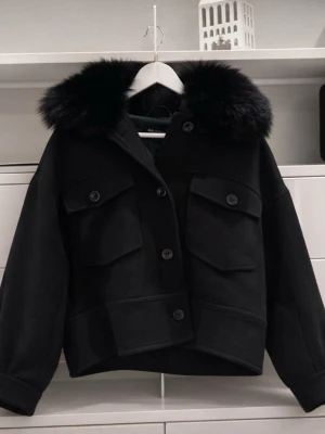 Svart pälsjacka meotine - Stilren svart pälsjacka från meotine med stor fluffig pälskrage. Jätte bra skick och inga defekter. Storlek s/m men skulle säga s