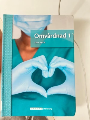 Omvårdnad 1 & Social omsorg 1 - Två kursböcker: 'Omvårdnad 1' av Kjell Hjelm och 'Social omsorg 1' av Cattrin Hurtig. Båda har hårda omslag med tydliga bilder på omsorgssituationer. Perfekta för dig som pluggar vård och omsorg på gymnasiet eller vuxenutbildning.