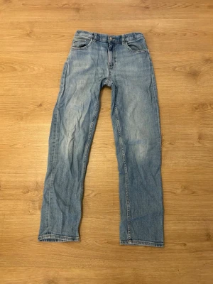 Ljusblå raka jeans med klassisk passform - NYPRIS: 400kr  Snygga ljusblå jeans med raka ben och klassisk femficksdesign. Jeansen har normal midja och är tillverkade i slitstarkt denimtyg. Perfekta för en avslappnad och stilren look. OBS: Som det syns på bilden så är jeansen sydda mellan benen, dock så är det  väldigt svårt att se när man har på sig dem.