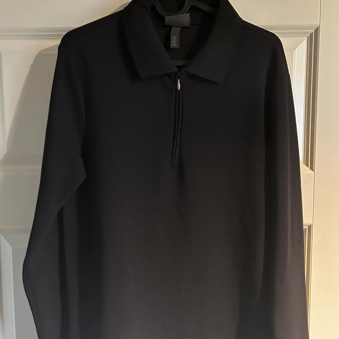 Svart pikétröja med half zip