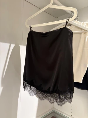 Svart tubtopp med spets Zara  - Säljer denna super snygga svarta toppen från Zara i storlek S, modellen är ” Glättrad topp med spets” helt oanvänd med prislapp kvar och även slutsåld på hemsidan