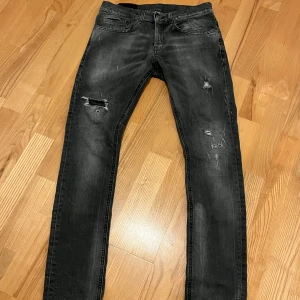 Dondup George 29 - Dondup jeans, storlek 29/29. Modellen på bilden är 178cm ish, 74kg. Fint skick inga defekter. Snygga slitningar, ingen hud syns i hålen. Skriv om minsta fundering!
