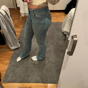 Bootcut jeans i ljusblå denim, 157 S - Säljer ett par ljusblå bootcut jeans från 157 i storlek S. Jeansen har klassisk femficksdesign, normalhög midja och är tillverkade i mjuk denim. Snygg passform med utsvängda ben och diskreta sömmar. Perfekta för dig som gillar en retro vibe.