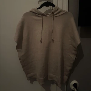 Beige stickad hoodie utan armar från Primark - Beige stickad hoodie från Primark med korta ärmar och huva. Jag säljer för 150kr + frakt som kunden betalar, priset kan diskuteras 