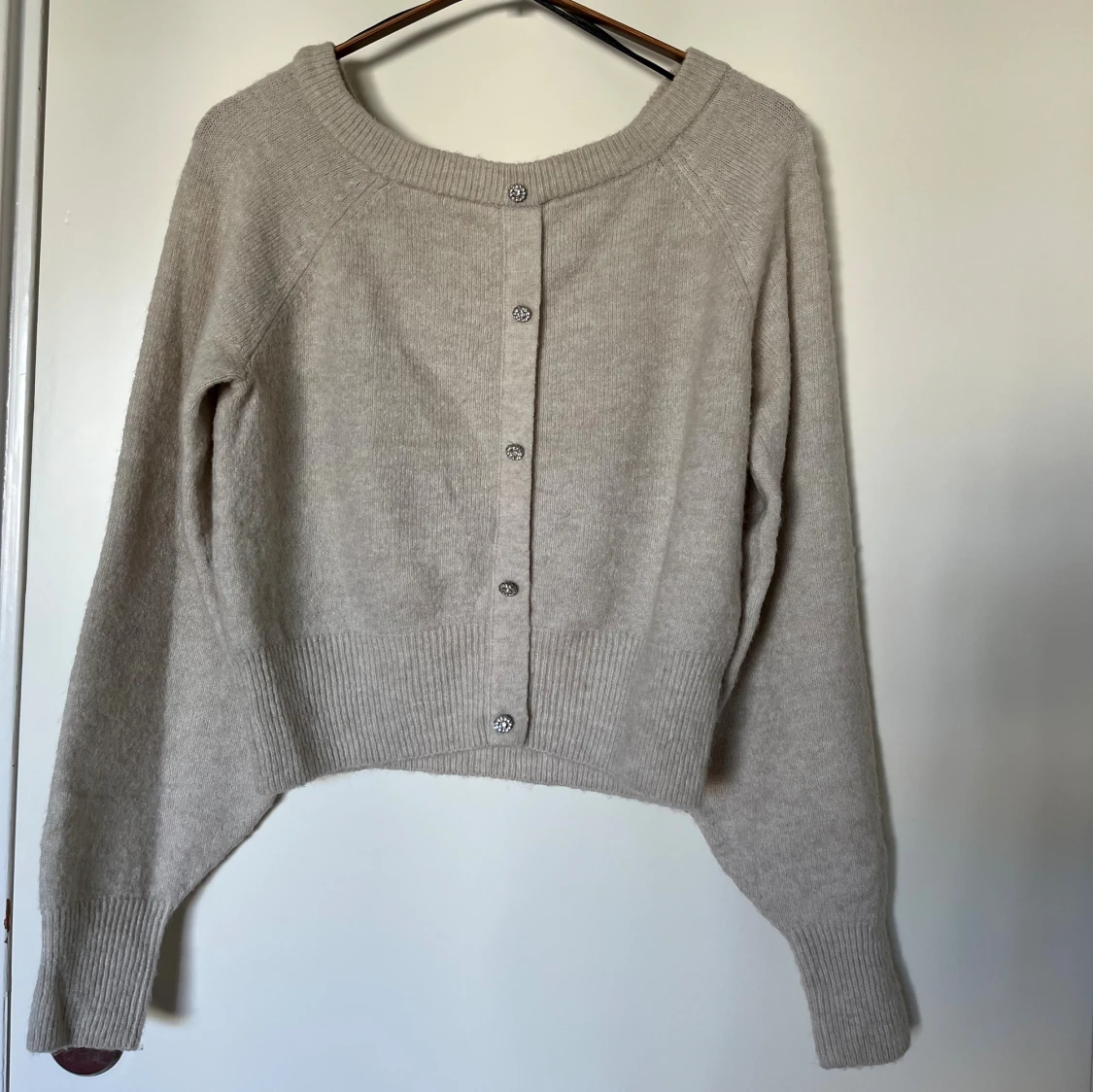 Beige stickad tröja med strassknappar