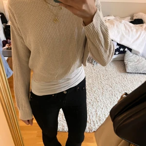 Beige stickad tröja  - Säljer en beige stickad tröja med lång ärm och rund hals. Tröjan har en ribbad kant vid ärmslut och nederkant, och är i en lite croppad modell. Perfekt att styla med jeans eller kjol för en chill look. Knappt anvönd, säljer då den inte kommer till användning. Jag är 170 och tröjan passar i armlängden men blir lite kroppad då storleken är 152. 