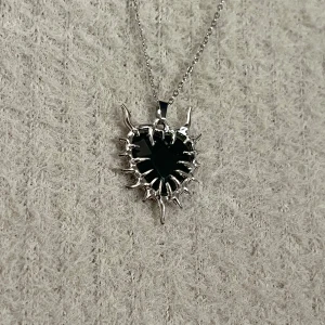Spiked Core - Black heart pendant with spikes converging toward the center. 50 cm stainless steel chain, raw and powerful