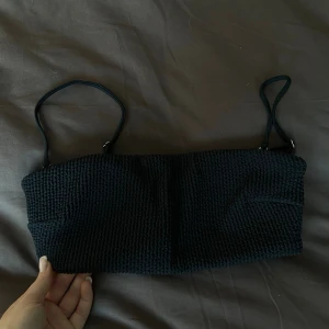 Svart bikini topp - Säljer en svart bikini topp med justerbara smala axelband och snyggt spänne i ryggen. Aldrig använd