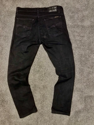 Svarta Nudie Jeans  - Säljer nu ett par snygga svarta nudie jeans✅ -fint skick (inga defekter)🙌🏼 -storlek W32 L34 (midjemått:41cm, längden:95 så passar mindre (slim fit)✅ Hör gärna av er vid frågor🙌🏼