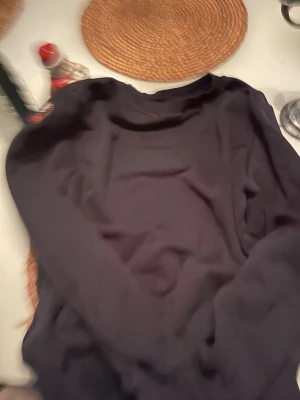 Svart fleece-tröja från Parajumpers - Svart långärmad fleece-tröja från Parajumpers med rund hals och ribbade muddar. Tröjan har en stilren look och är perfekt för kyliga dagar. Märkespatch på ärmen ger en snygg detalj. Passar dig som gillar enkel och clean stil.