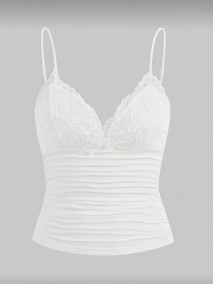 Vit spetslinnetopp med rosett - Säljer en vit linnetopp med tunna axelband och v-ringad spets upptill. Toppen har en liten rosett framtill och ribbad, lätt rynkad nederdel. 