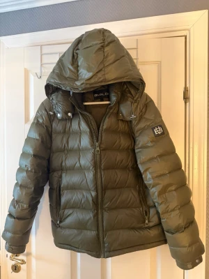 Olivgrön dunjacka från Bvaldi Shop - Asfet grön vinterjacka från bvaldi i nytt skick, jackan är använd ca 5 gånger