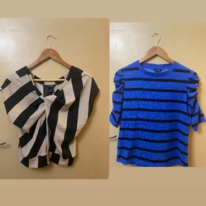 Två randiga toppar från Lindex - Säljer två snygga toppar från Lindex! Ena är beige och svart med breda vertikala ränder och lös passform, den andra är blå med svarta horisontella ränder och puffiga korta ärmar. Perfekta för dig som gillar färg och mönster.