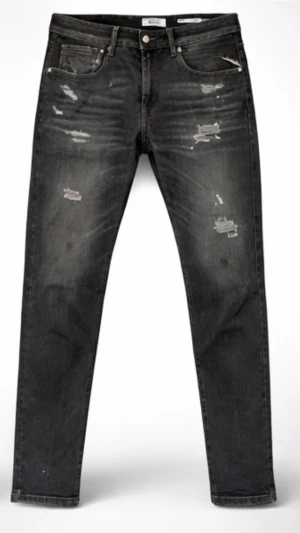 Svarta Replay Jeans - Säljer ett par svarta skinny jeans med slitna detaljer och snygg tvätt. Jeansen har klassisk femficksdesign och dragkedjegylf. Perfekta för dig som gillar en lite tuffare stil.