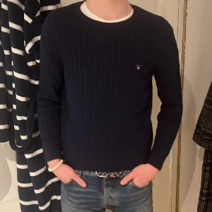 Kabelstickad gant tröja - Säljer denna kabelstickad gant sweatshirten i material bomull. De står i tröjan att den är i barn storlek (158/164) mensen  sitter som XS, både jag och min vän är 180 och den är lrätt liten,modellen är ju då 180, hör av er vid frågor och funderingar!